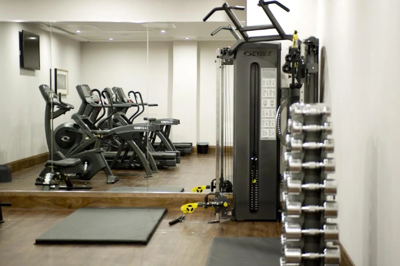 a gym with several treadmills and cardio machines at Clayton Hotel Birmingham in Birmingham
