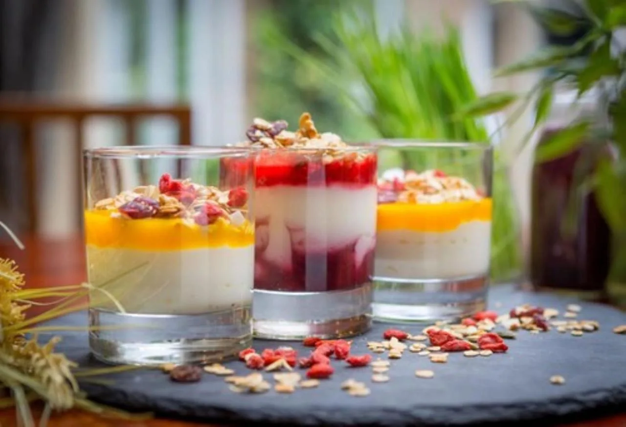 three desserts in glasses sitting on a table at Clayton Hotel Birmingham in Birmingham